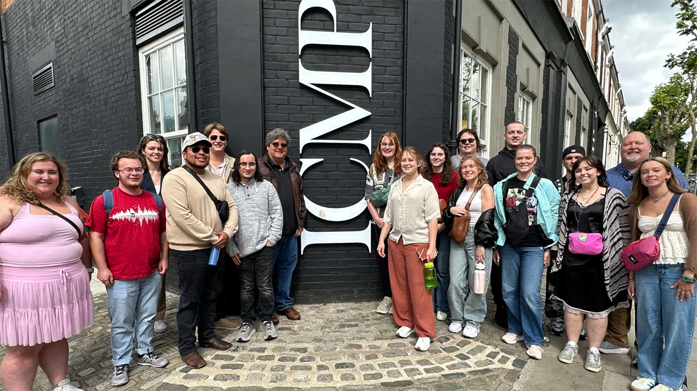 Middle Tennessee State University Recording Industry Department faculty members Bill Crabtree, center left next to signage, and Odie Blackmon, second from far right, take a group photo during a weeklong study abroad trip they led earlier this summer with MTSU students. The group was visiting the Institute of Contemporary Music Performance in London, England, where Sony Music A&R executive Julian Palmer spoke to the group, and students also had the opportunity to spend one-on-one time with Palmer, write songs and record music. (Submitted photo)